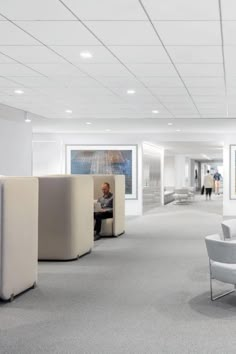 an office with white walls and carpeted flooring