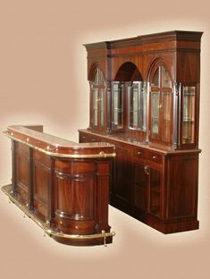 a wooden bar with glass front doors and two cupboards on the side, in an antique style