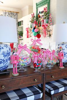 a table topped with lots of candy and candies on top of wooden dressers