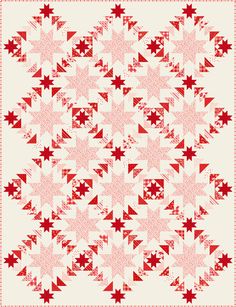 a red and white quilt with stars on the front, in an old fashioned style