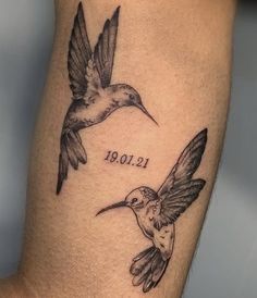 two hummingbirds flying next to each other with the word love tattooed on their legs