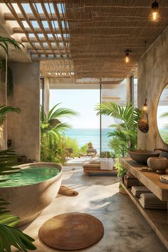 a bathroom with a large bathtub next to the ocean