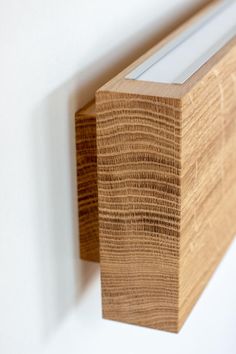 a close up of a wooden shelf with a glass window on it's side