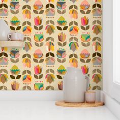 the wallpaper in this kitchen is very colorful