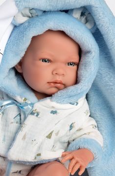 a baby doll with a blue blanket on it's head is posed for the camera