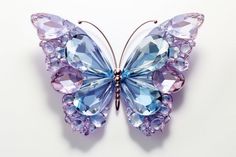 a butterfly shaped brooch sitting on top of a white table next to a wall