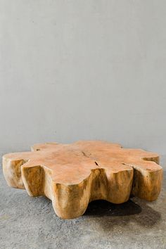 a wooden table sitting on top of a cement floor