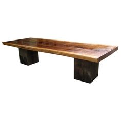 a large wooden table sitting on top of a white wall