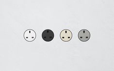 three different types of electrical plugs on a white wall