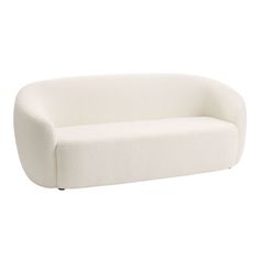 a white couch sitting on top of a white floor