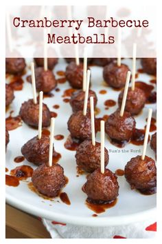 cranberry barbecue meatballs on a white plate with toothpicks in them