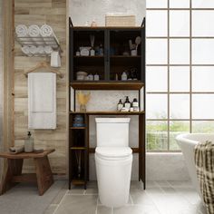 a white toilet sitting in a bathroom next to a bath tub and wooden shelves filled with towels