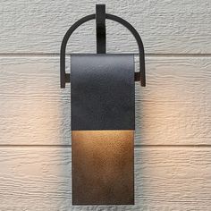 a black and brown light fixture on a white wall