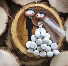 wedding cake topper with bride and groom on wood slice for decoration or centerpiece