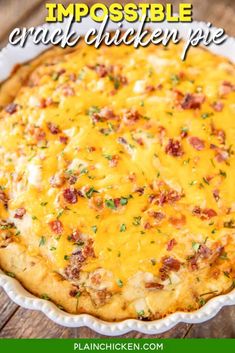 a cheesy casserole in a white dish on top of a wooden table