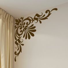 the wall is decorated with an ornate design on it's side, along with curtains and drapes