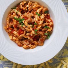 a white bowl filled with pasta and sauce