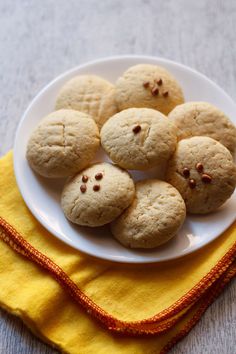 a white plate topped with cookies on top of a yellow towel