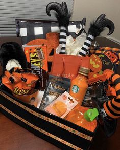 a suitcase filled with halloween items on top of a table