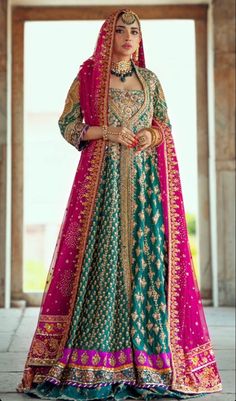 a woman in a green and pink bridal gown