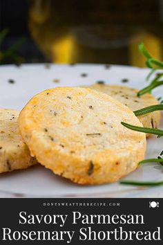 two rosemary shortbreads on a white plate with text overlay that reads savory parmesan rosemary shortbread