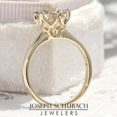 a close up view of a ring on a white cloth with the words joseph schrrach jewellers