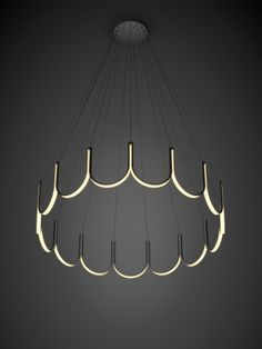 a modern chandelier hanging from the ceiling in a dark room with dim lighting