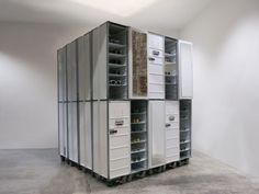 several metal filing cabinets stacked on top of each other in a room with white walls