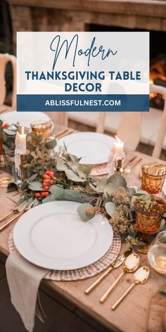 a table set for thanksgiving dinner with white plates and silverware, greenery and candles