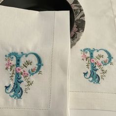 two embroidered napkins on top of each other