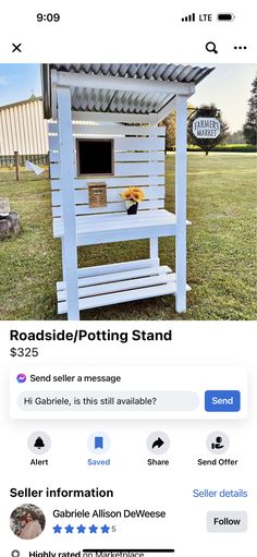 a white wooden stand sitting on top of a field next to a sign that says roadside / potting stand