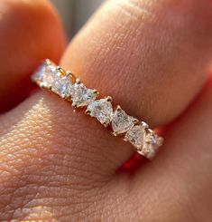 a woman's hand with a diamond ring on it