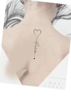 the back of a woman's neck with a heart tattoo on it