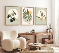 three paintings on the wall above a white chair and table in a room with wood flooring