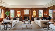 a living room filled with lots of furniture and a grand piano in the middle of it