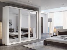 a bedroom with mirrored closet doors in it