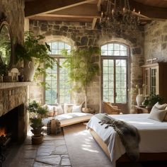 a bedroom with stone walls and flooring has a large bed in front of a fireplace