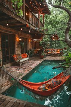 an orange boat sitting on top of a wooden deck next to a swimming pool in front of a house