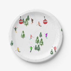 a paper plate with skiers and pine trees on the side, in front of a white background