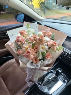 a bouquet of flowers sitting on the dashboard of a car