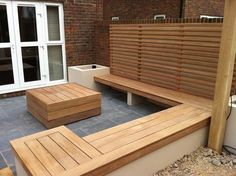 a wooden bench sitting on top of a stone patio