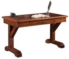 a wooden desk with a pen and paper on the top, in front of a white background