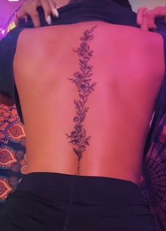 the back of a woman's body with flowers on it