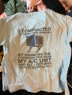 a t - shirt that has been placed on top of some clothes and other items