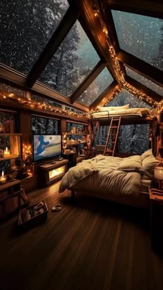 a bed sitting under a skylight in a bedroom next to a window filled with lights