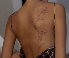 the back of a woman's body with flowers on it