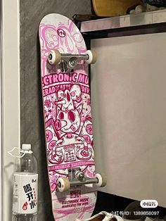 a skateboard is hanging on the wall next to a water bottle and other items