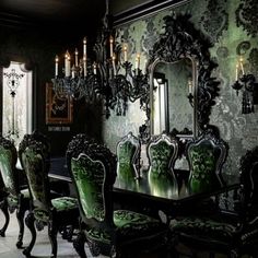 an ornate dining room with green chairs and chandelier above the table in front of a large mirror