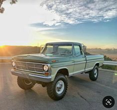 an old pick up truck is parked on the road