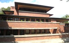 a large brick building with lots of windows on the top floor and second story above it